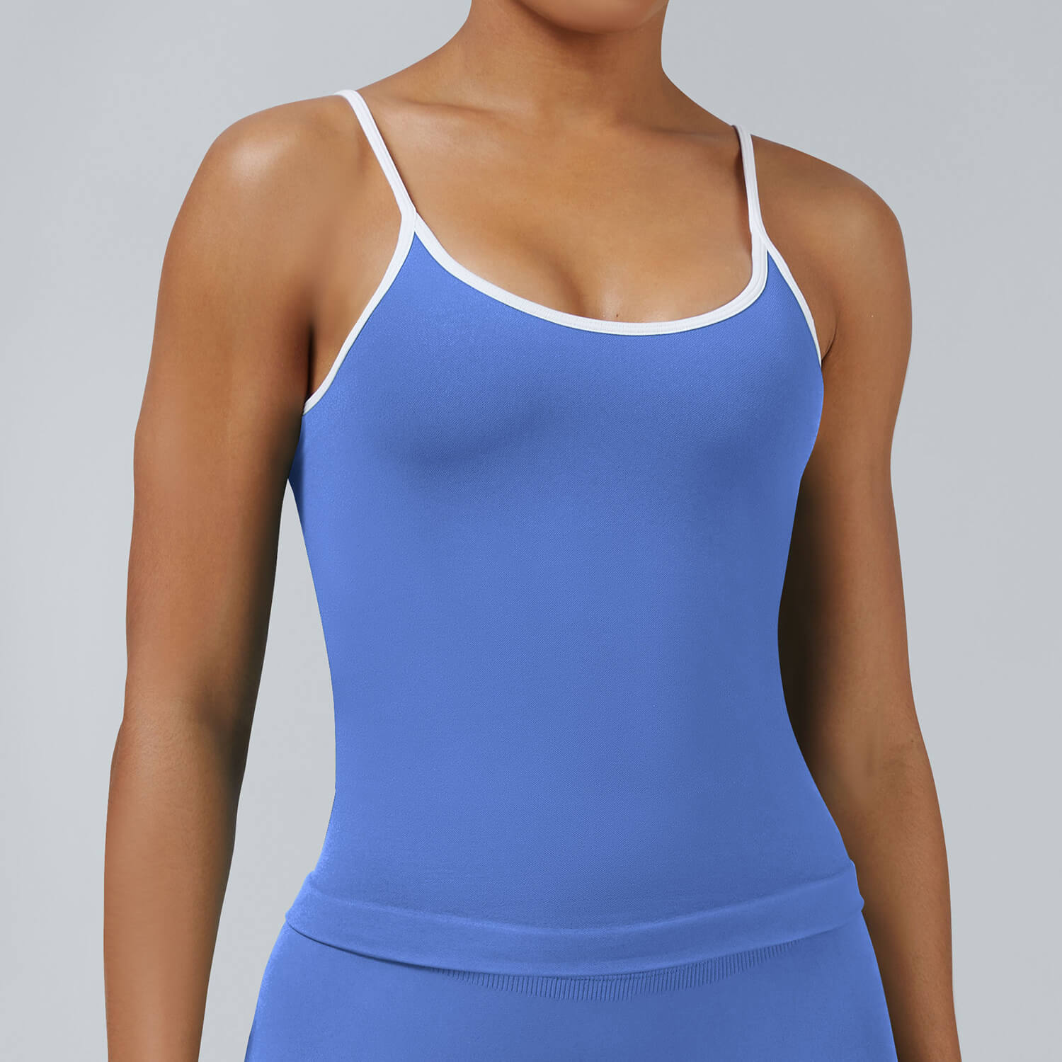blue seamless workout cami tank with removable pads and white contrast edges, ideal for fitness and casual activewear