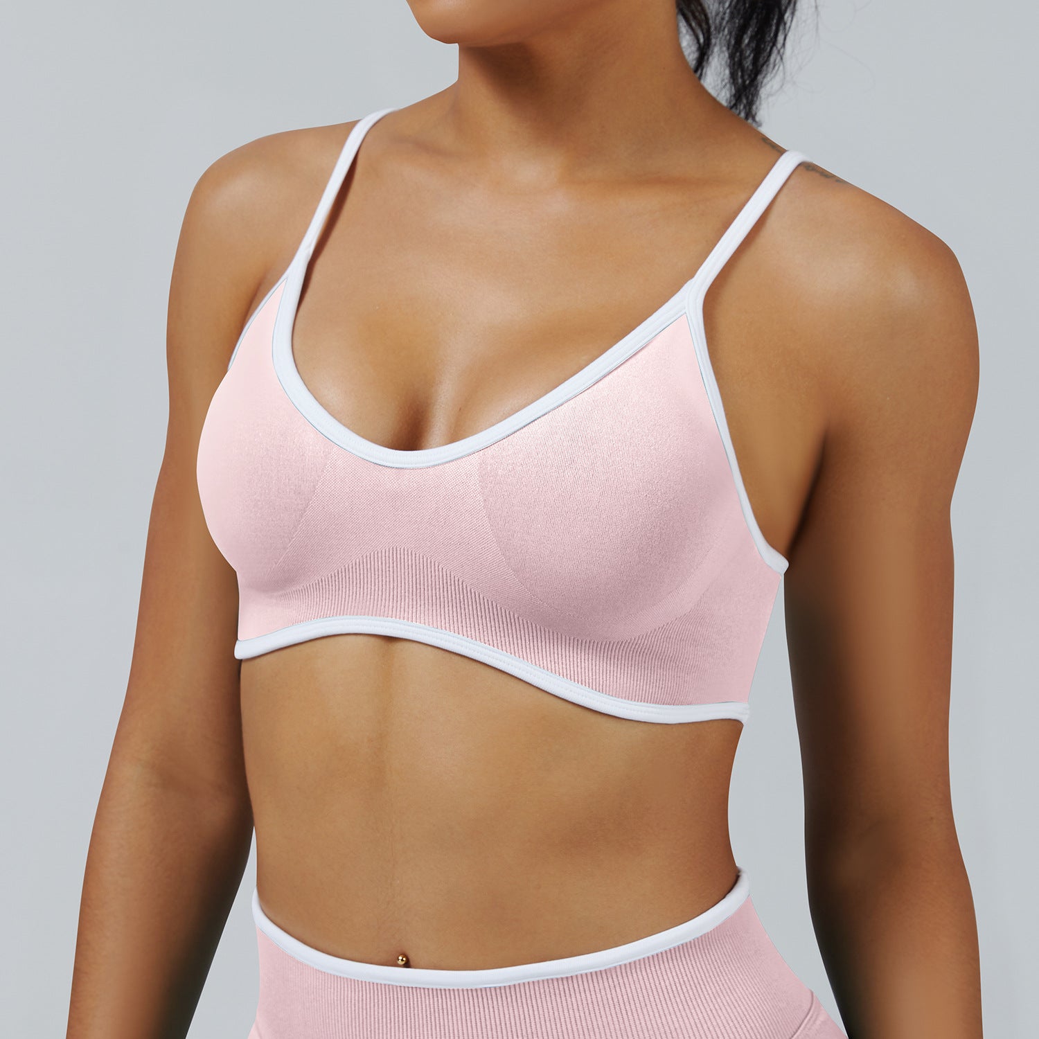 Soft Pink seamless sports bra with white trim detail